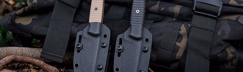 Camping Knife Essentials: Your Guide to Choosing the Right Blade for the Outdoors Two tactical knives with textured handles in black sheaths resting on a camouflage backpack outdoors, ideal for camping, survival, or bushcraft gear setups.