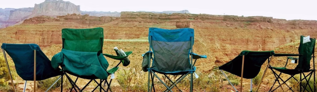 Camping Chairs Comfort Guide: Your Ultimate Seat for Outdoor Bliss Foldable camping chairs arranged on rocky ground overlooking a desert canyon, perfect for outdoor relaxation and scenic views.