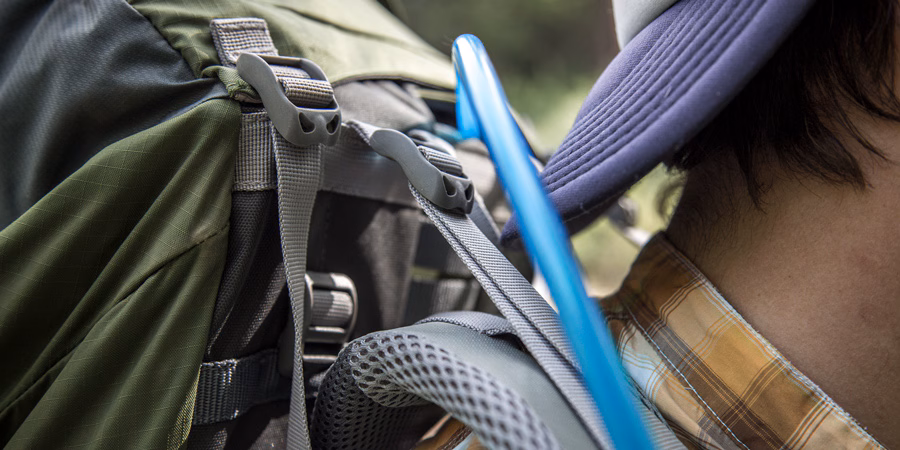 Camping Backpack Size Guide: Finding Your Perfect Fit 4 Close-up of backpack load lifters and shoulder straps designed for hiking or tactical use, showing durable stitching and heavy-duty buckles for weight distribution and comfort